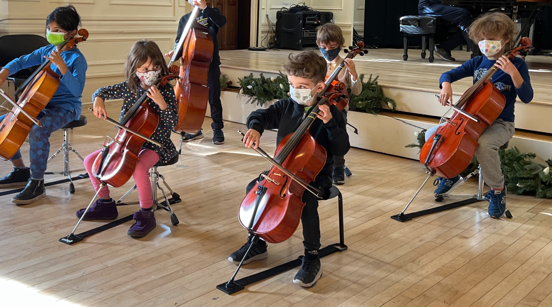Young cellists in a group cello class together